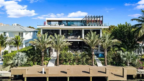 a view of a large building with a lot of plants and trees