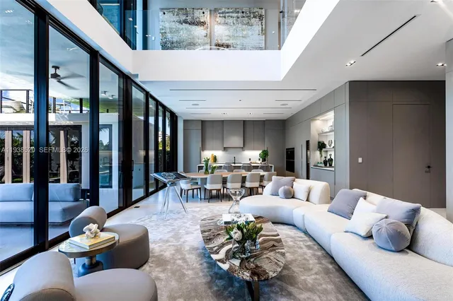 a dining room with stainless steel appliances kitchen island granite countertop a dining table and chairs