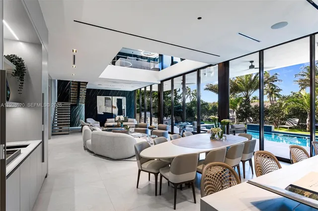 a dining room with stainless steel appliances a dining table and chairs
