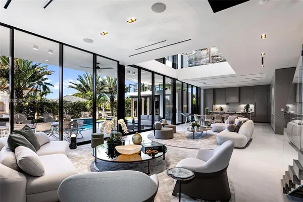 a dining room with stainless steel appliances kitchen island granite countertop a dining table and chairs