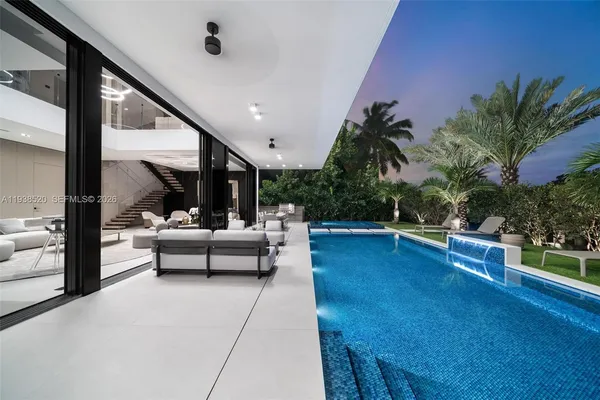 a bedroom with a bed and large window