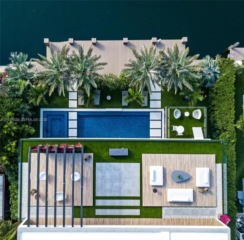 a living room with furniture and floor to ceiling windows