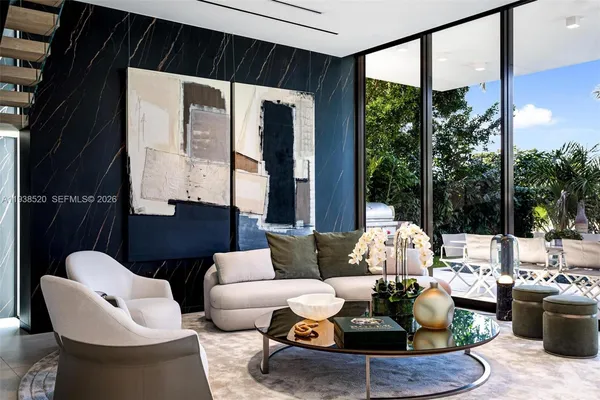 a living room with furniture potted plant and a large window