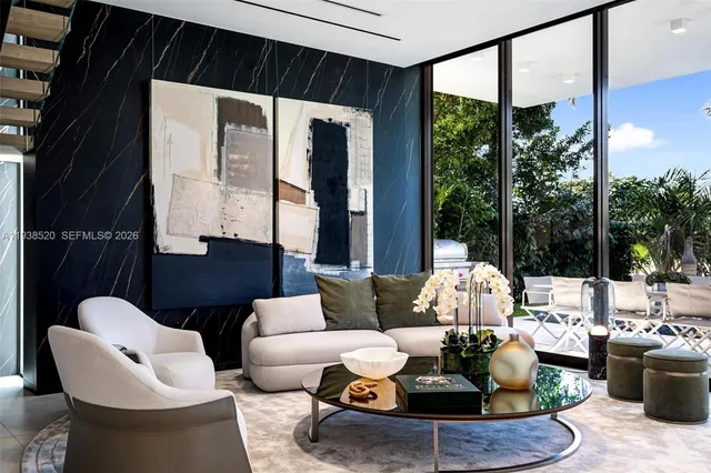 a living room with furniture and a potted plant