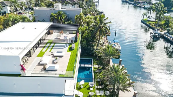 a view of a house with swimming pool and sitting area