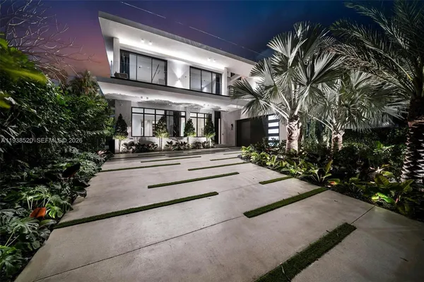 a living room with furniture and potted plants