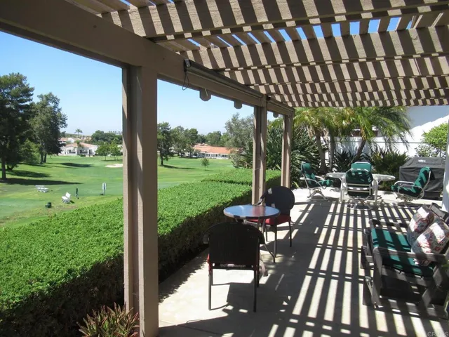 a view of a patio with a table chairs and a patio