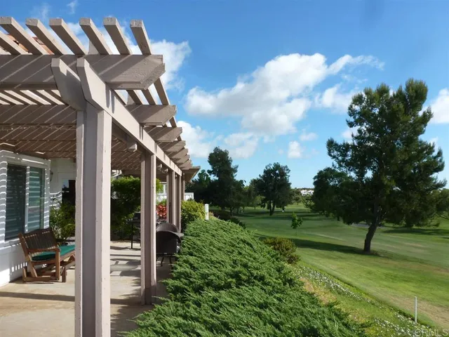 a bathroom with a granite countertop sink a mirror and shower