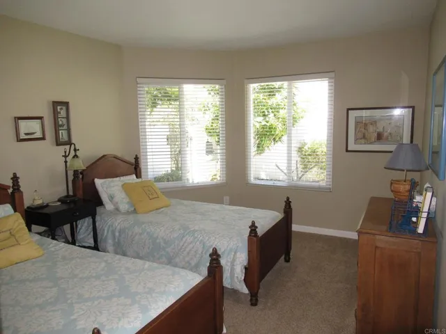 a living room with furniture a chandelier and wooden floor