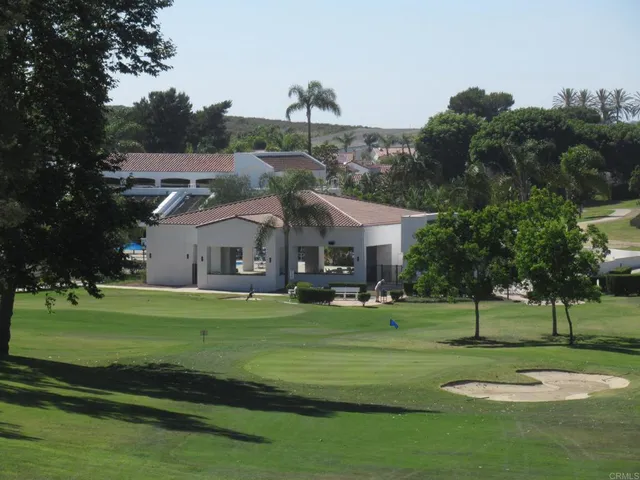 a view of a patio with table and chairs under an umbrella