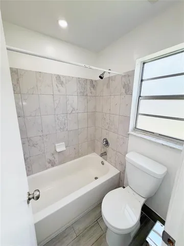a bathroom with a toilet and a bathtub