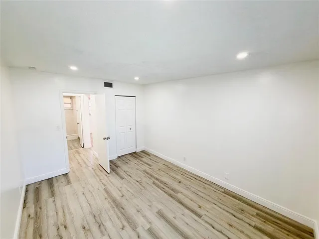 a view of hallway with wooden floor