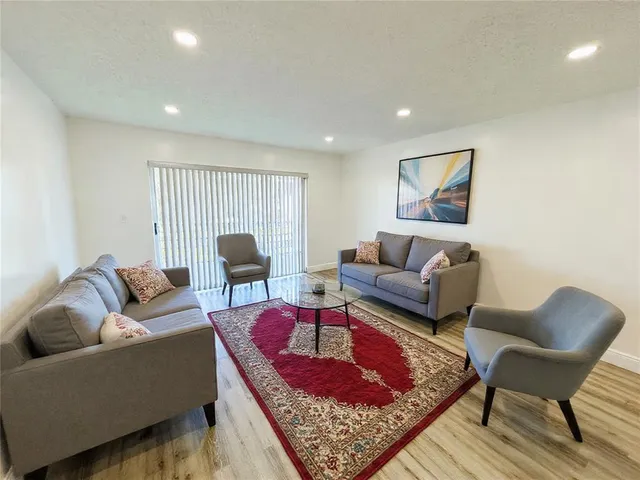 a living room with furniture and a rug