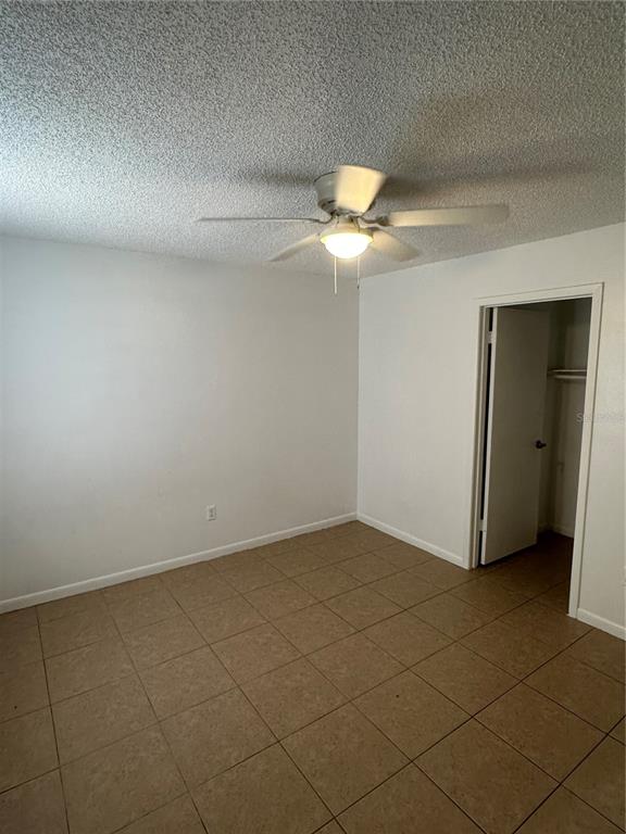 2218 Leo Drive, Unit B Auburndale, FL 33823 - Photo 6 of 9 an empty room with a ceiling fan and carpet