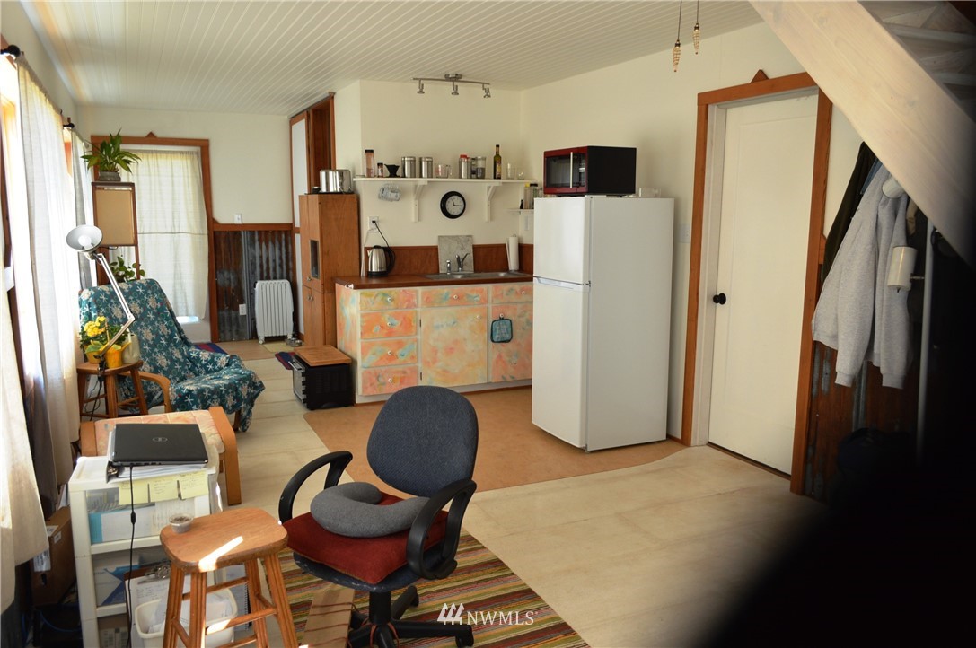 7855 Ham Road Custer, WA 98240 - Photo 21 of 39 a living room with furniture a flat screen tv and a refrigerator