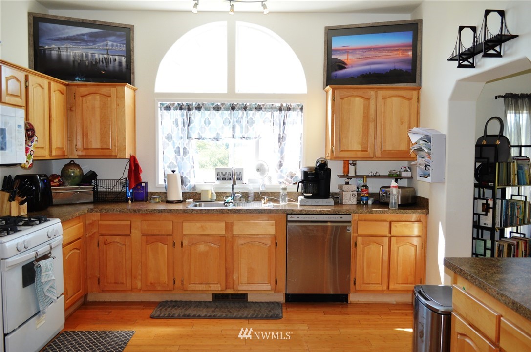7855 Ham Road Custer, WA 98240 - Photo 10 of 39 a kitchen with stainless steel appliances granite countertop a stove a sink and a refrigerator