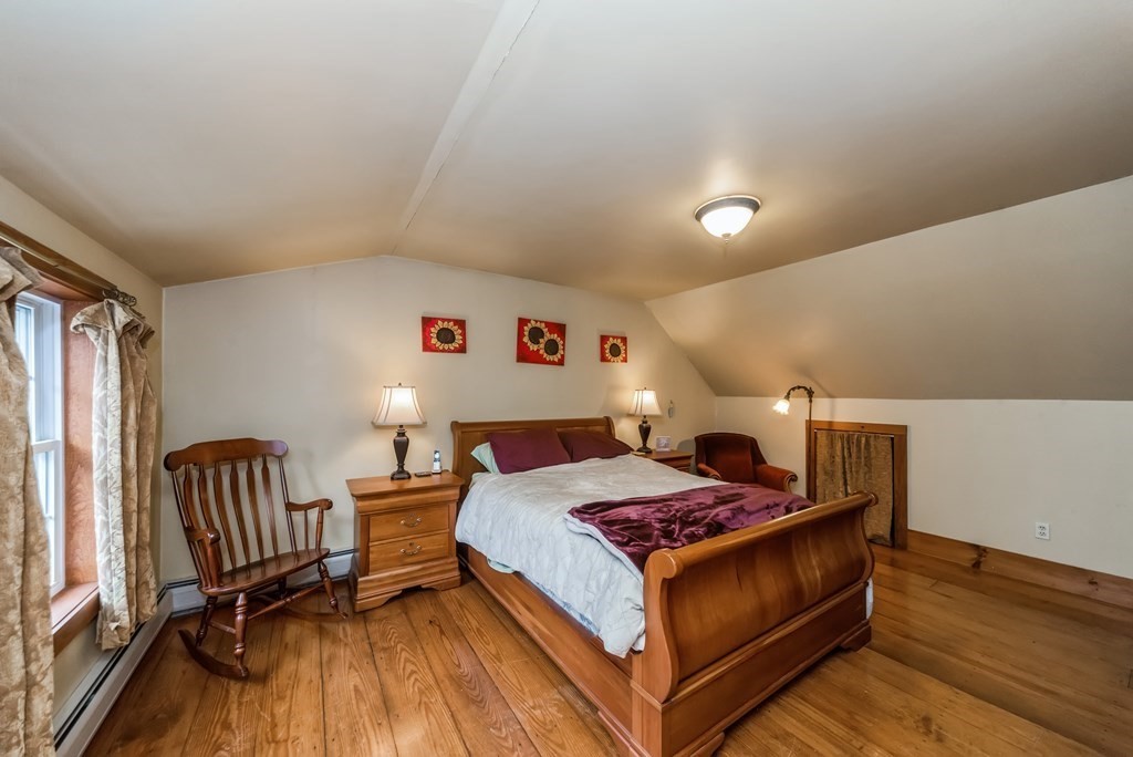 50 Old Poor Farm Road Ware, MA 01082 - Photo 22 of 33 a living room with a bed and a table