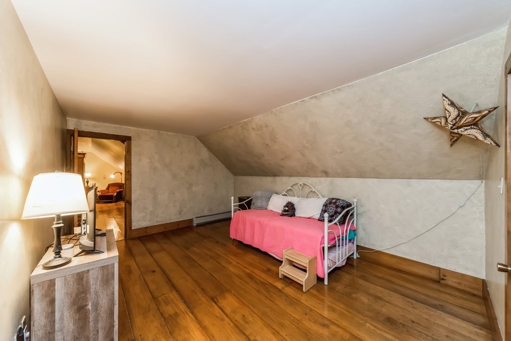 50 Old Poor Farm Road Ware, MA 01082 - Photo 23 of 33 a bedroom with a bed and wooden floor