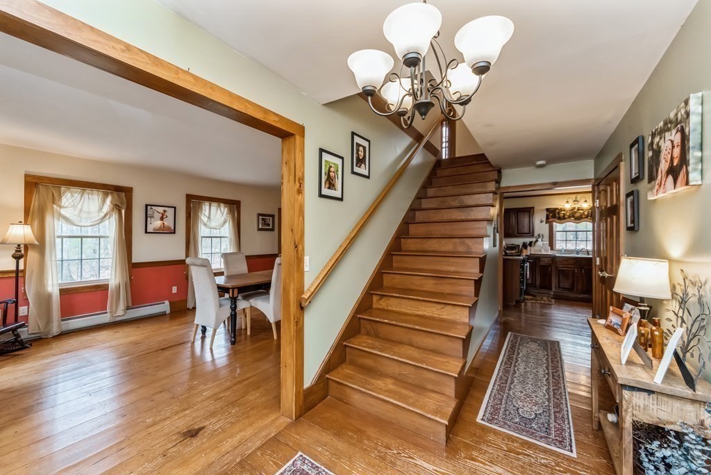 50 Old Poor Farm Road Ware, MA 01082 - Photo 3 of 33 a view of a livingroom with furniture wooden floor and chandelier