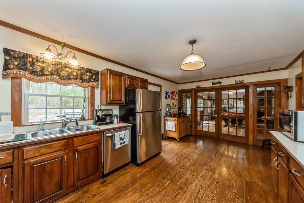 50 Old Poor Farm Road Ware, MA 01082 - Photo 5 of 33 a kitchen with stainless steel appliances granite countertop a stove a sink and a refrigerator with wooden floor