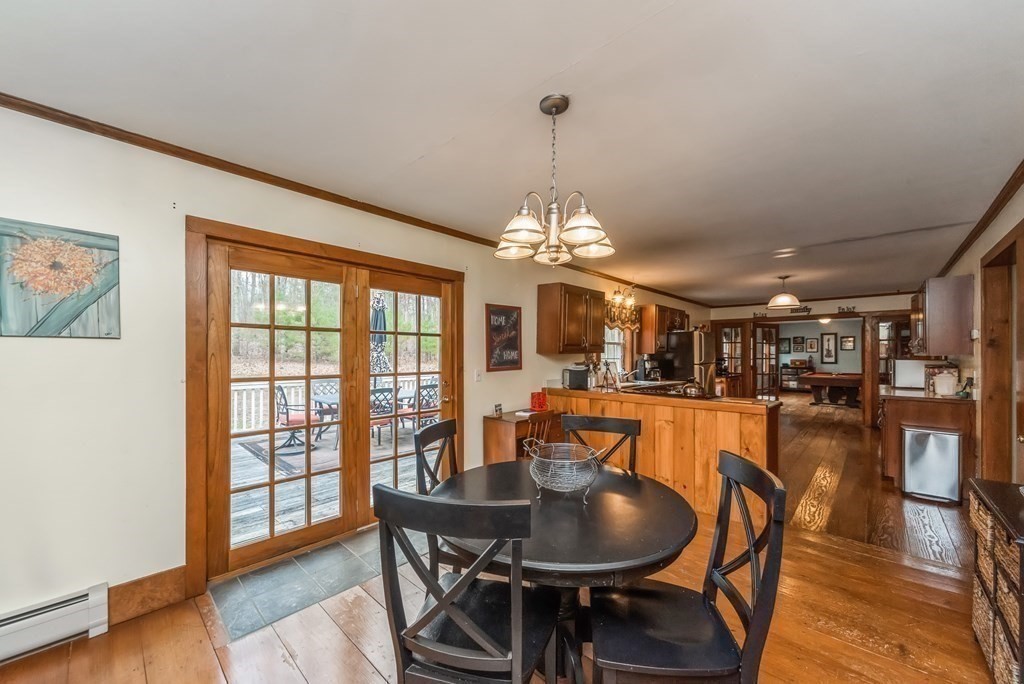 50 Old Poor Farm Road Ware, MA 01082 - Photo 10 of 33 a dining room with furniture a chandelier and wooden floor