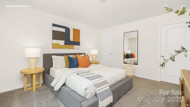 a bedroom with a bed and a lamp