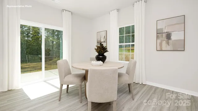 a dining room with furniture window and wooden floor