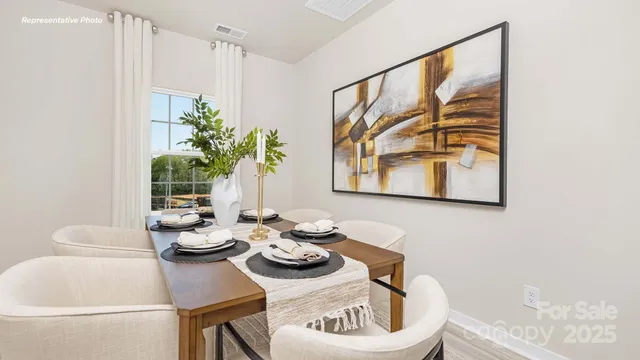 a view of a dining room with furniture and a potted plant