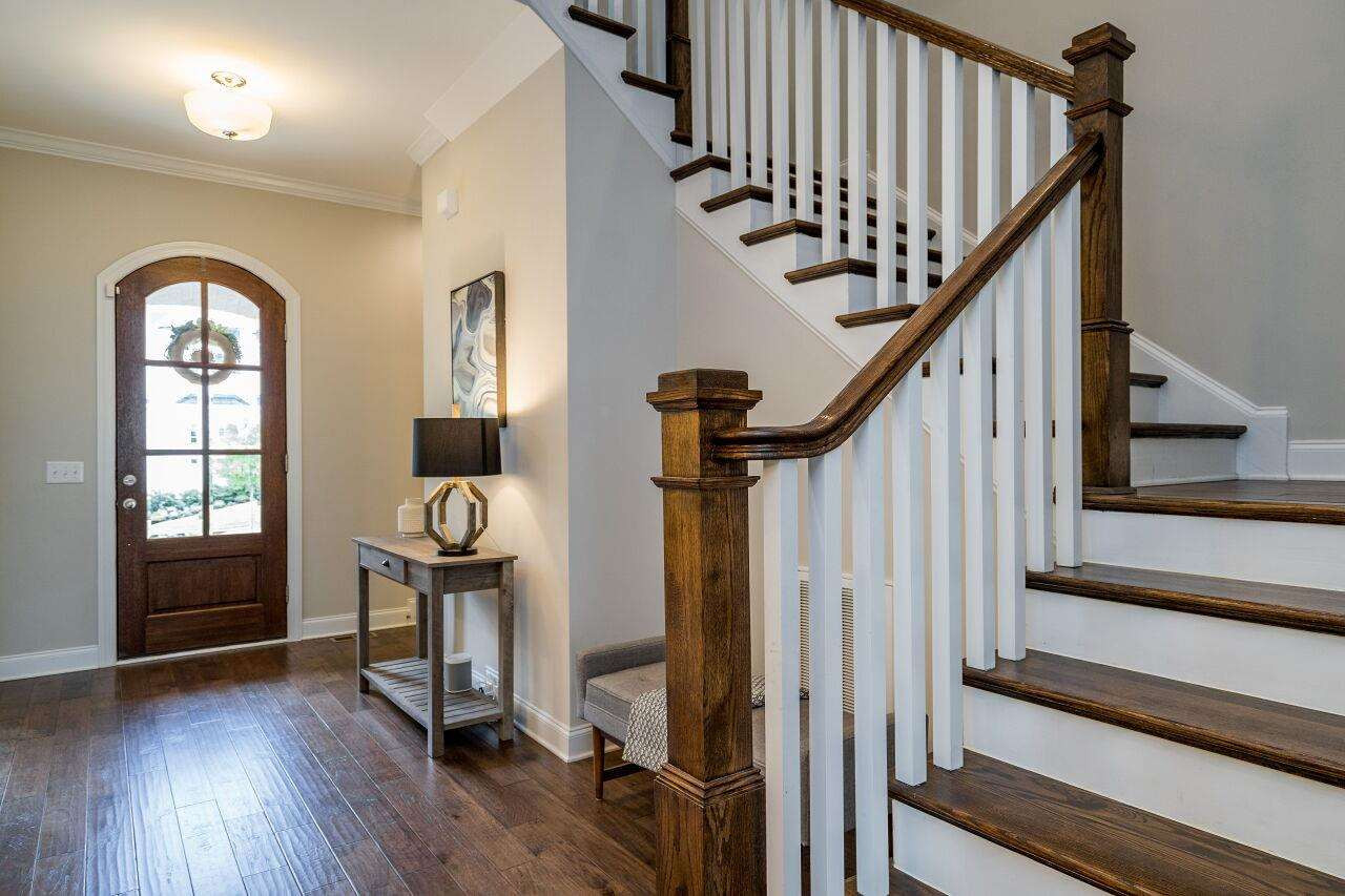 5264 Aleppo Lane Raleigh, NC 27613 - Photo 3 of 30 Light filled foyer greets you with powder room, open staircase and engineered hardwoods. Foyer