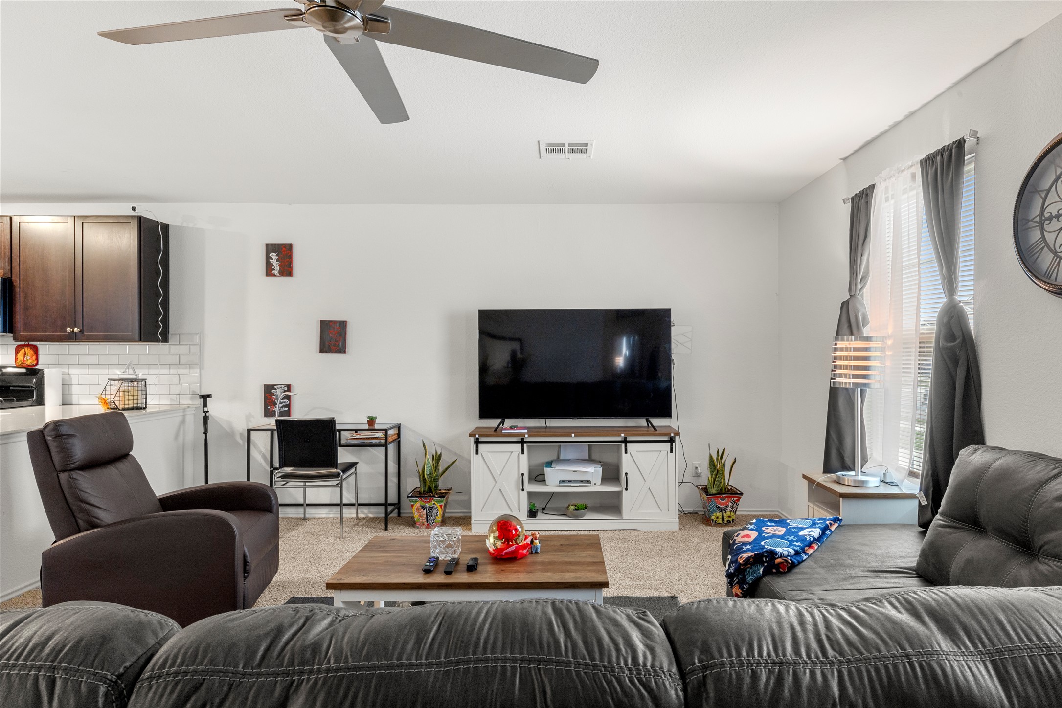 17701 Oso Cove Elgin, TX 78621 - Photo 2 of 9 Carpeted living area with a ceiling fan