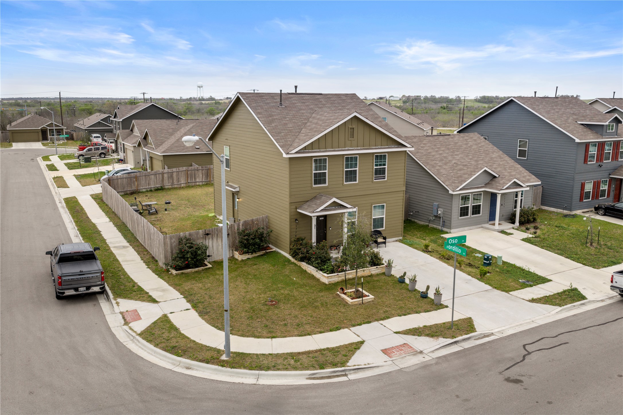 17701 Oso Cove Elgin, TX 78621 - Photo 8 of 9 View of front of property featuring roof with shingles, a residential view, and board and batten siding