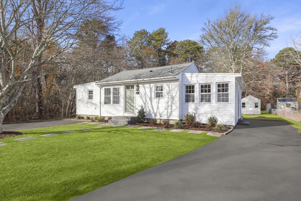 21 Weston Avenue Wareham, MA 02571 - Photo 1 of 23 a front view of a house with a garden and trees