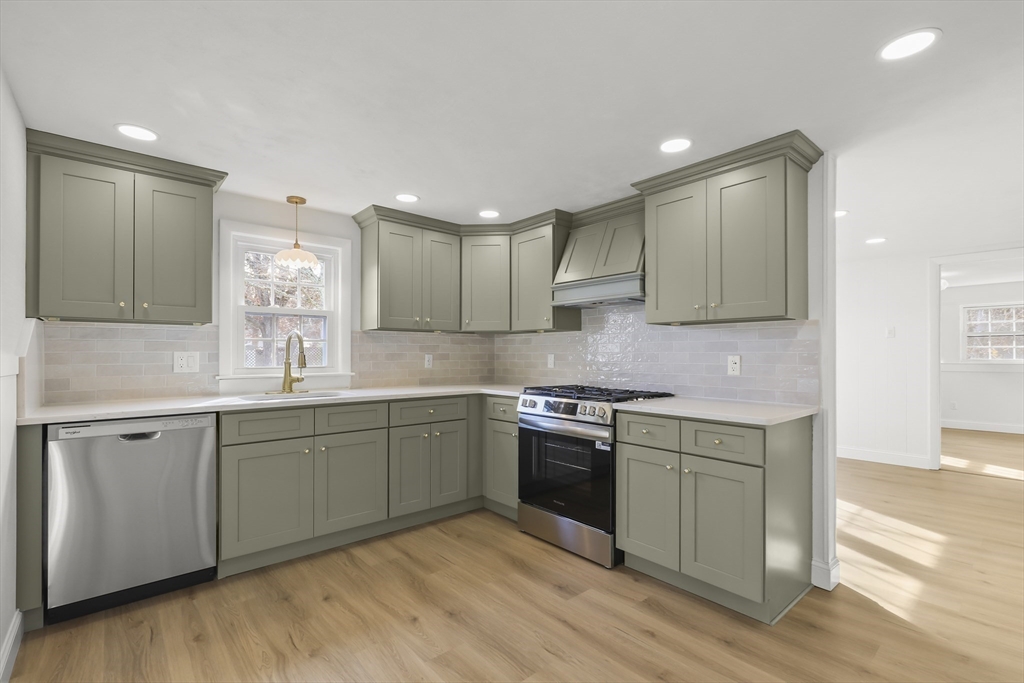 21 Weston Avenue Wareham, MA 02571 - Photo 3 of 23 a kitchen with stainless steel appliances granite countertop a sink and stove top oven