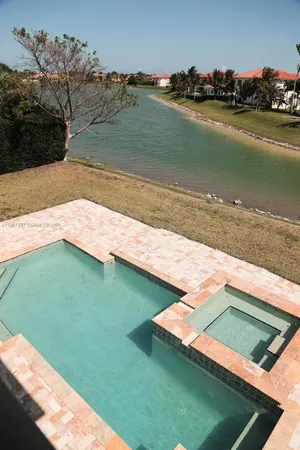 a view of a lake with lawn chairs