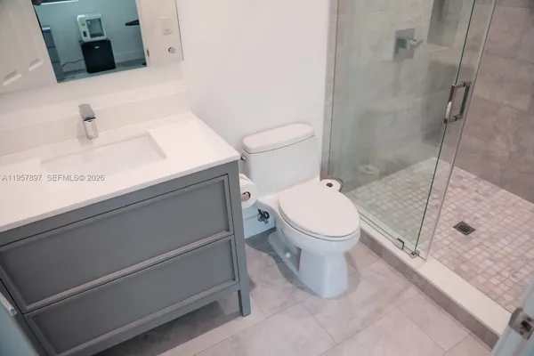 a view of a living room with furniture and a floor to ceiling window