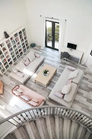 a living room with furniture and wooden floor