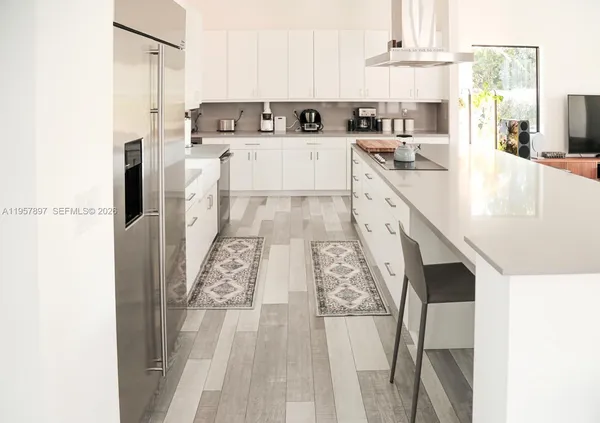 a kitchen with stainless steel appliances cabinets a sink and a counter