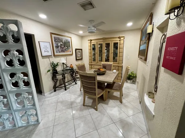 a dining room with furniture and window