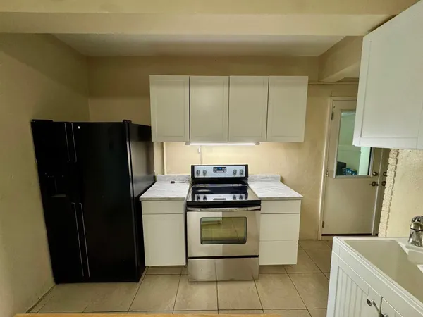 a kitchen with a stove and a refrigerator