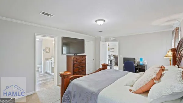 a spacious bathroom with a double vanity sink a mirror and a toilet