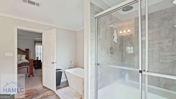 a bedroom with furniture and a flat screen tv