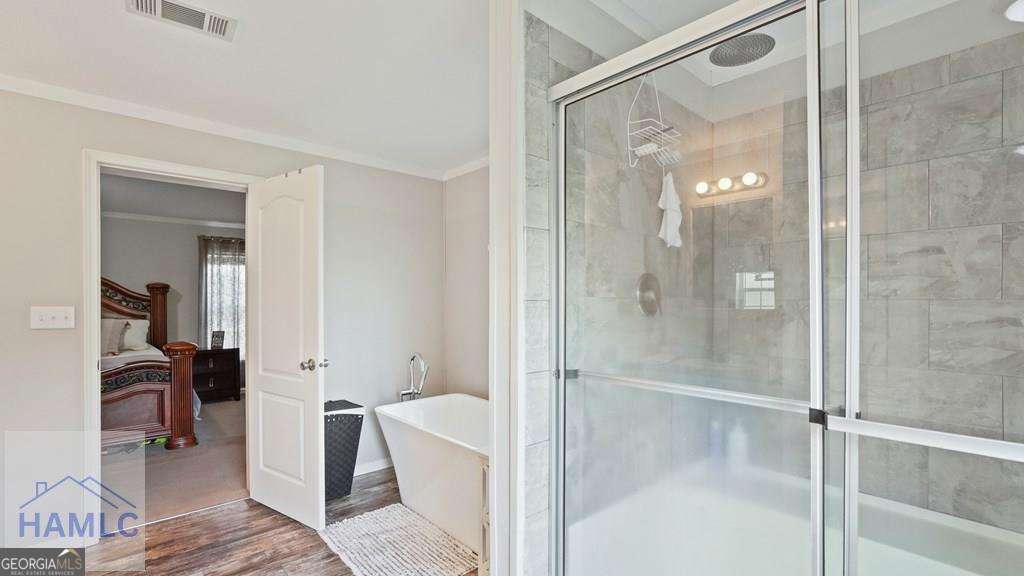 876 Hires Road Jesup, GA 31545 - Photo 19 of 30 a bathroom with a glass shower door and a glass door