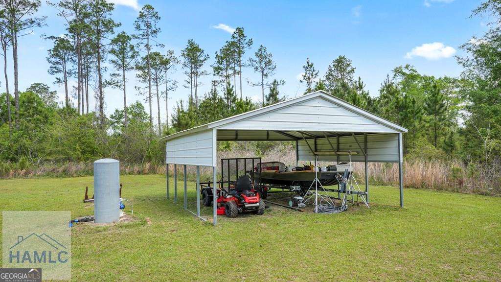 876 Hires Road Jesup, GA 31545 - Photo 25 of 30 a patio with table and chairs under an umbrella