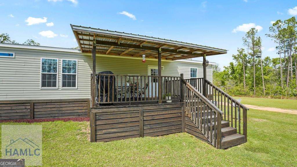 876 Hires Road Jesup, GA 31545 - Photo 27 of 30 a view of a house with backyard and sitting area