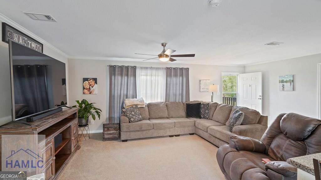 876 Hires Road Jesup, GA 31545 - Photo 9 of 30 a living room with furniture and a flat screen tv
