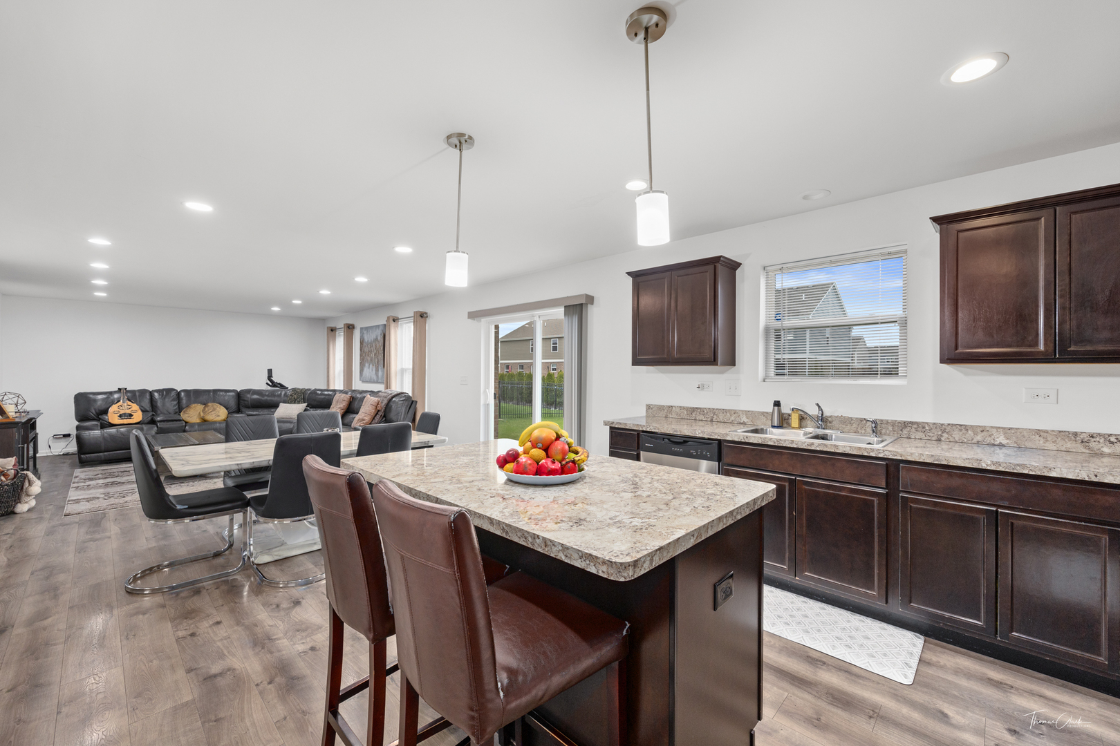 1978 Stapleton Road New Lenox, IL 60451 - Photo 15 of 47 a open kitchen with stainless steel appliances granite countertop a kitchen island a sink dishwasher a dining table and chairs with wooden floor