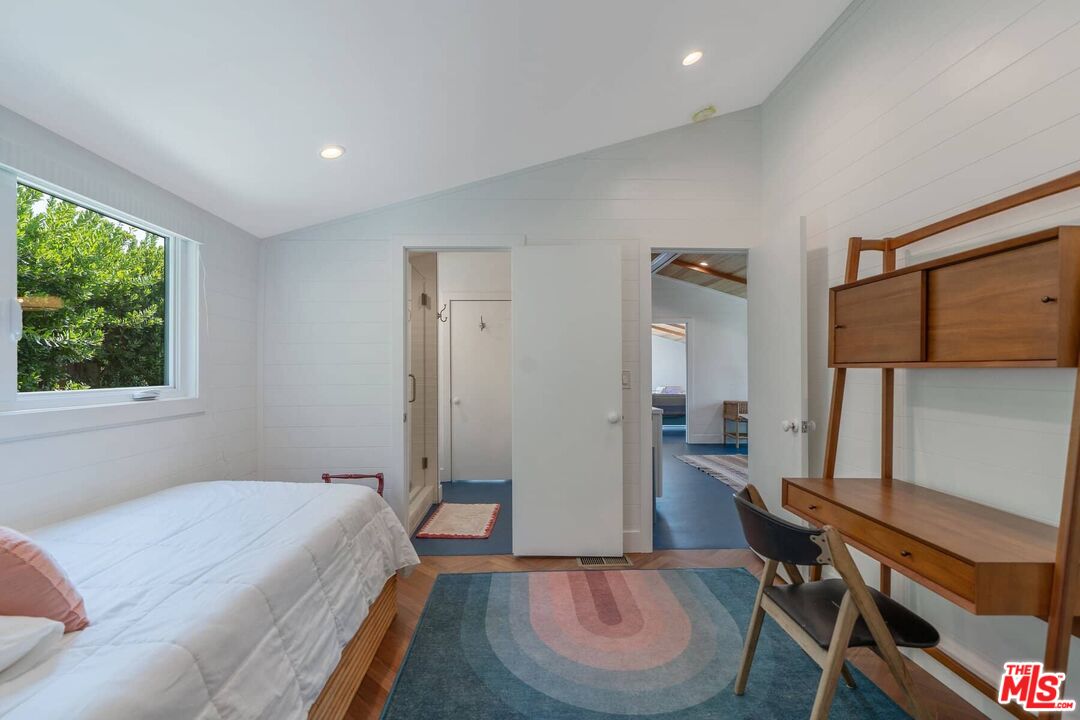 249 Paradise Cove Road Malibu, CA 90265 - Photo 18 of 41 a spacious bedroom with a bed and a table in it