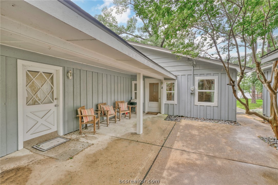 11452 Riley Green Road Franklin, TX 77856 - Photo 3 of 31 a view of a patio with table and chairs and floor to ceiling window
