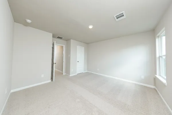 an empty room with windows and closet