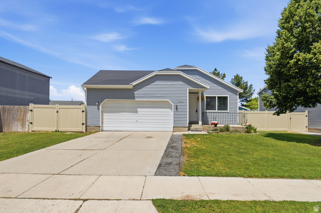 7910 Woolley Way Magna, UT 84044 - Photo 1 of 26 Single-story residence featuring light blue siding and a dark shingle roof